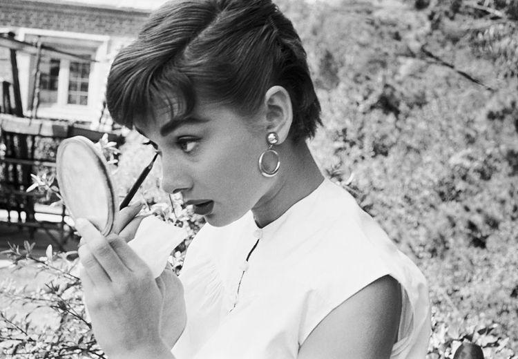 Audrey Hepburn Putting on Makeup in Mirror 1953